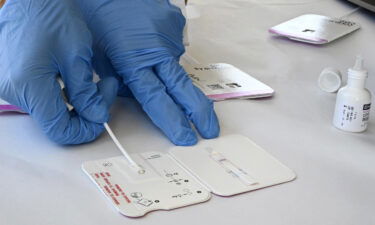 A rapid COVID-19 test swab is processed at Palos Verdes High School in Palos Verdes Estates