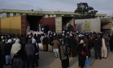 The Biden administration moves to allow Afghan teachers' salaries to be paid by aid organizations. Afghan teachers are seen lining up to receive humanitarian assistance in Mazar-i-Sharif