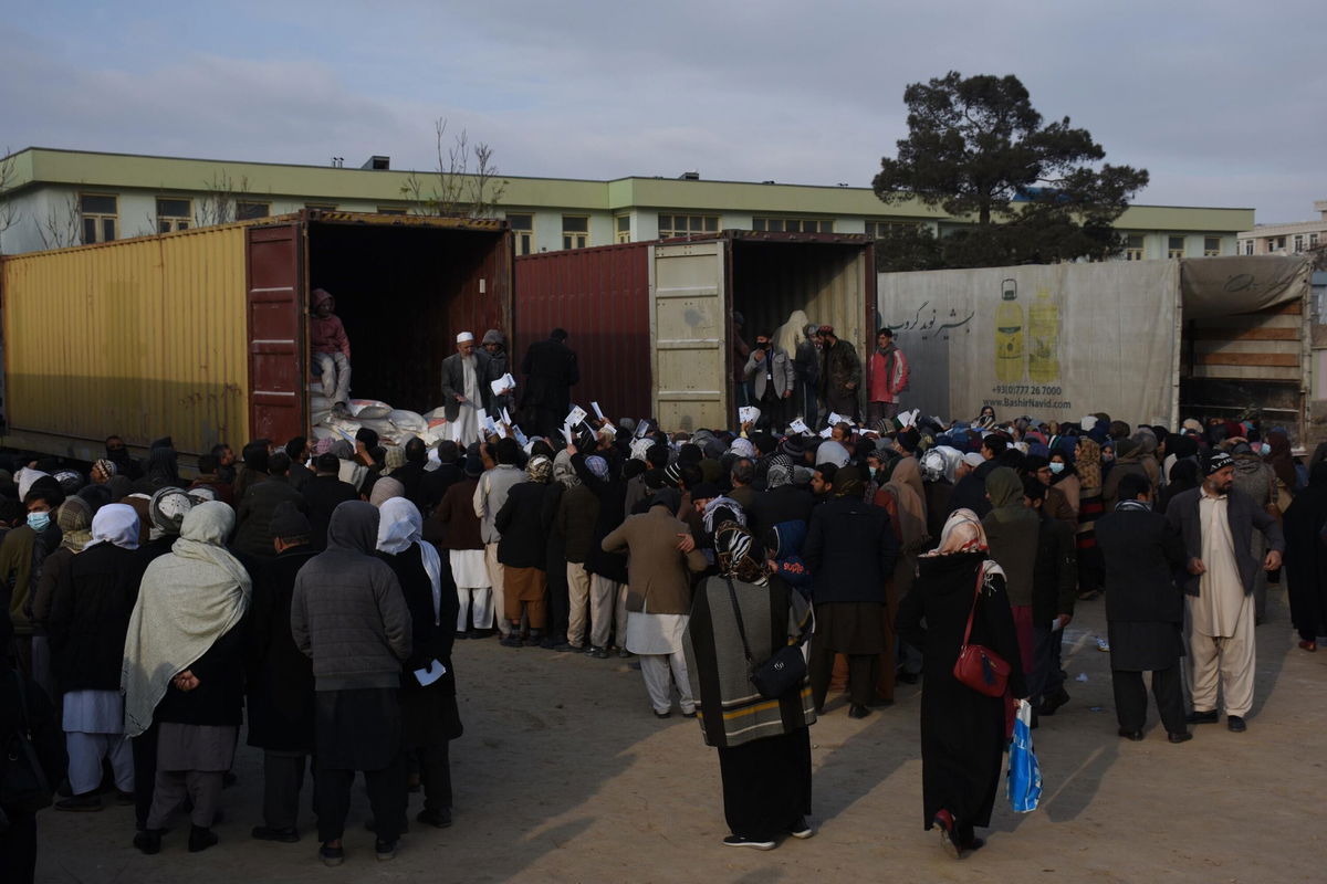 <i>Kawa Basharat/Xinhua News Agency/Getty Images</i><br/>The Biden administration moves to allow Afghan teachers' salaries to be paid by aid organizations. Afghan teachers are seen lining up to receive humanitarian assistance in Mazar-i-Sharif