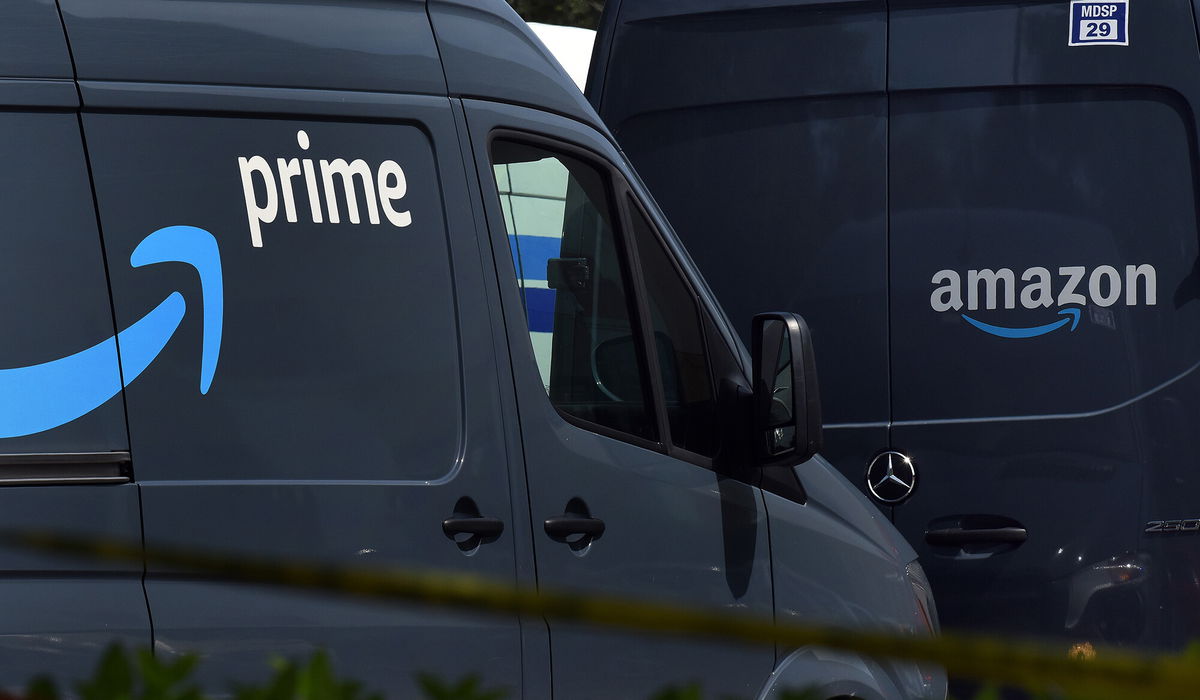 <i>Paul Hennessy/NurPhoto/Getty Images</i><br/>Amazon vans line up to pick up packages for delivery.