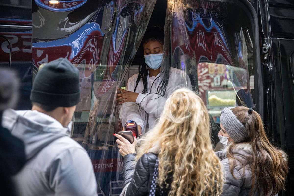 <i>Jeenah Moon/Bloomberg/Getty Images</i><br/>Some scientists think there is more evidence that Covid-19 is on its way to eventually becoming a seasonal endemic disease. A healthcare worker is shown here assisting residents at a Covid-19 test at mobile testing site near Rockerfeller Center in New York