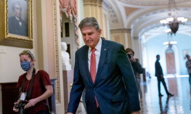 Goldman Sachs cuts US economic forecast after Joe Manchin rejects the Build Back Better bill. Manchin is seen here at the Capitol in Washington