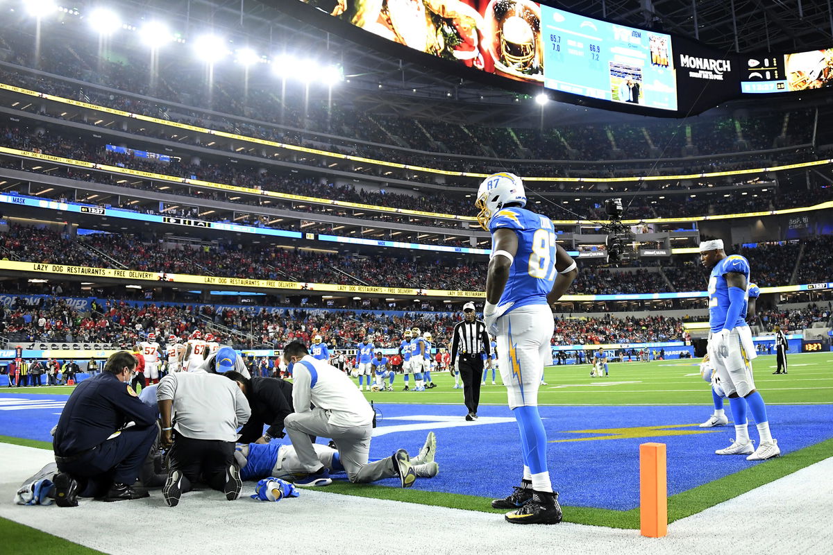 <i>Kevork Djansezian/Getty Images</i><br/>Jared Cook watches as Parham Jr. is assessed for injury in the first quarter of the game against the Chiefs at SoFi Stadium.