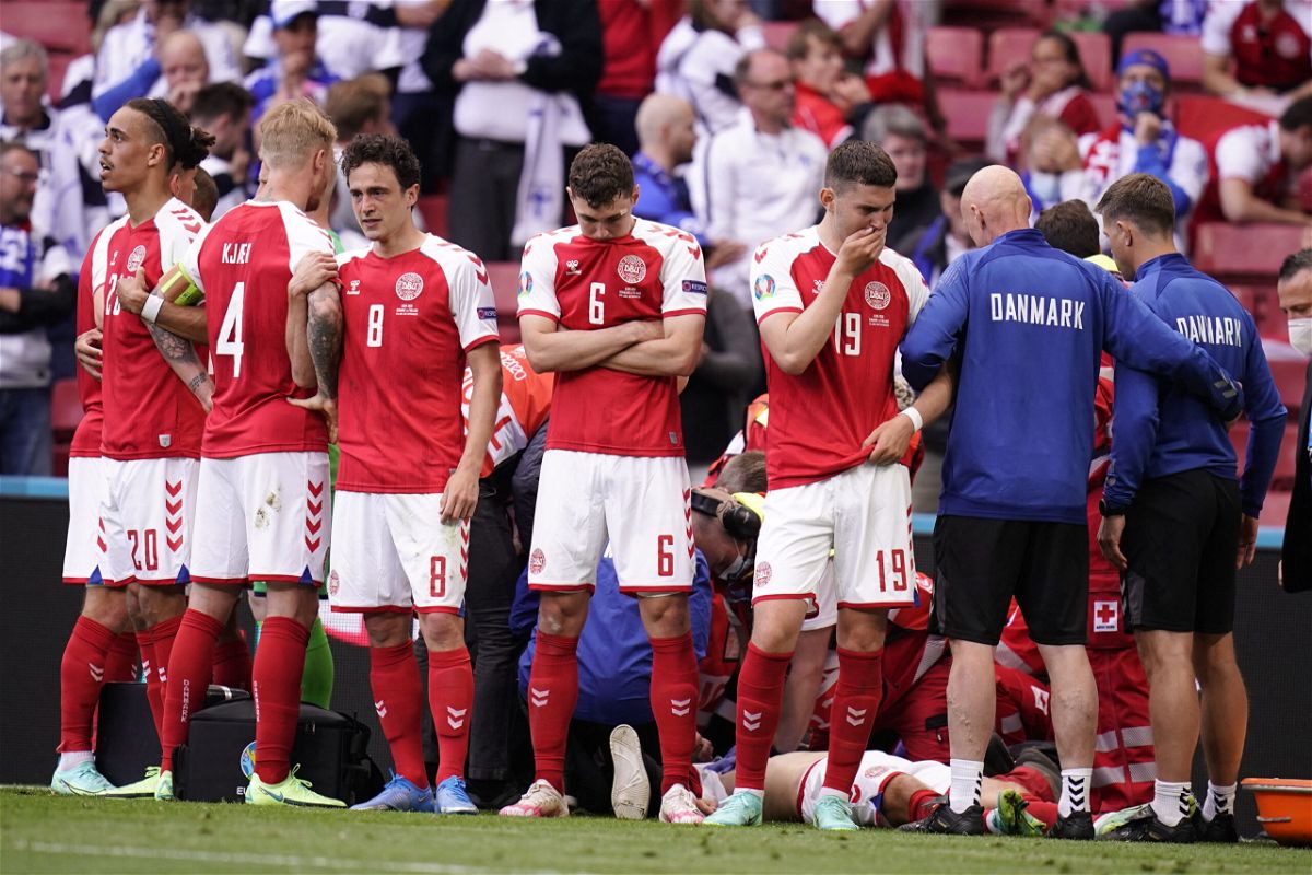 <i>Liselotte Sabroe/Ritzau Scanpix/AFP/Getty Images</i><br/>Denmark's players react as paramedics attend to Christian Eriksen after he collapsed on the pitch in June.