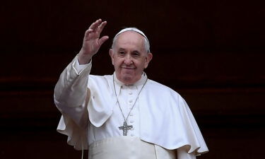 Pope Francis waves following his Christmas blessing in St. Peter's Square on December 25.