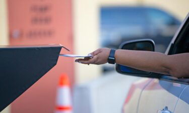 A Broward County resident deposits a ballot at the official dropbox during the 2020 election on November 3