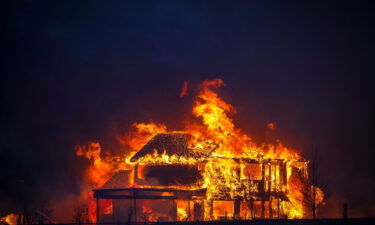 A home burns Thursday after flames swept through the Centennial Heights neighborhood of Louisville