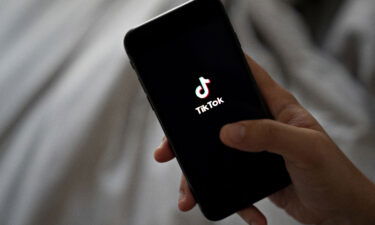 Signage for ByteDance Ltd.'s TikTok app is displayed on a smartphone in an arranged photograph taken in Arlington