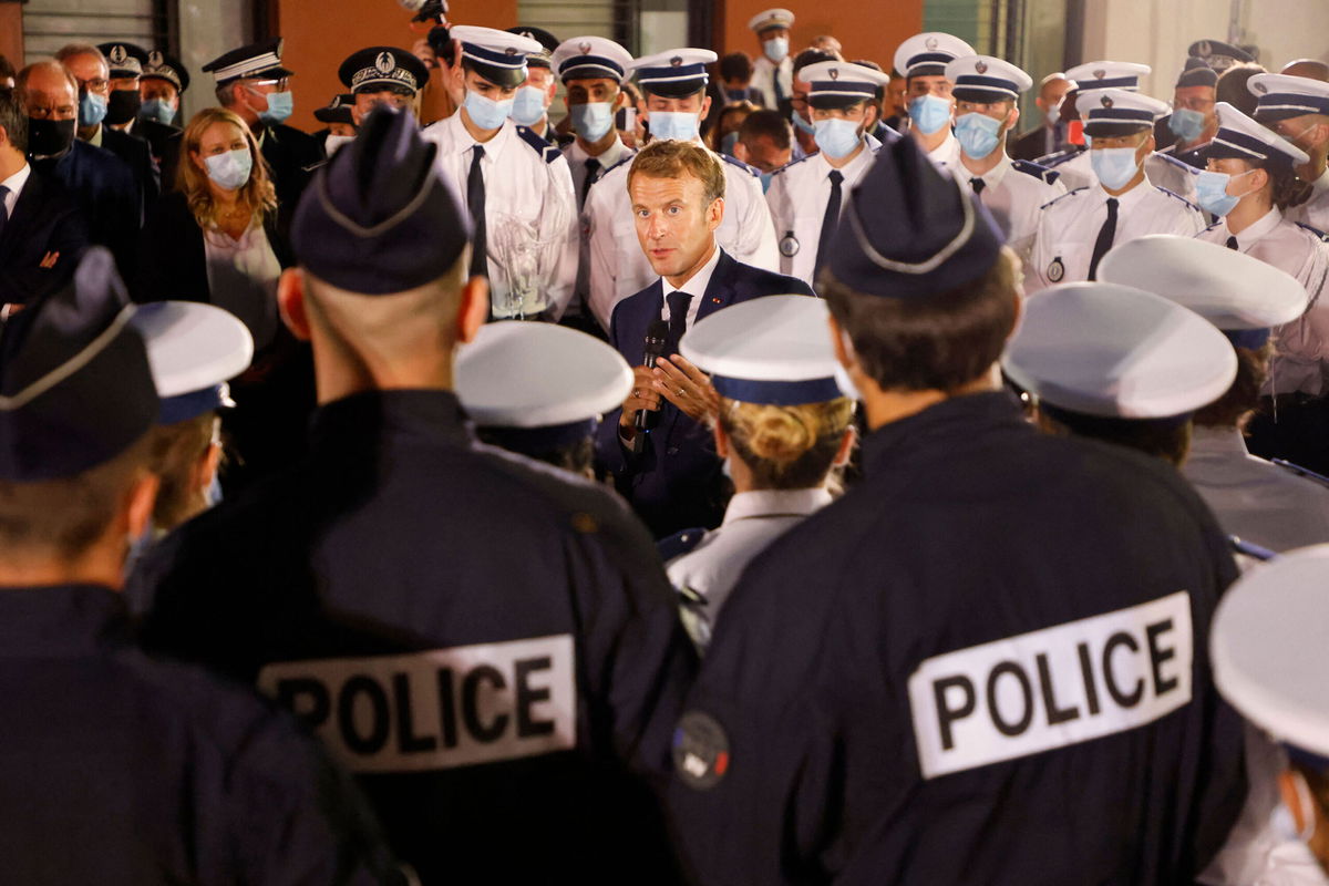 <i>Ludovic Marin/AFP/Getty Images</i><br/>French President Emmanuel Macron talks to police officers during a visit to a police station in northern Marseille on September 1.