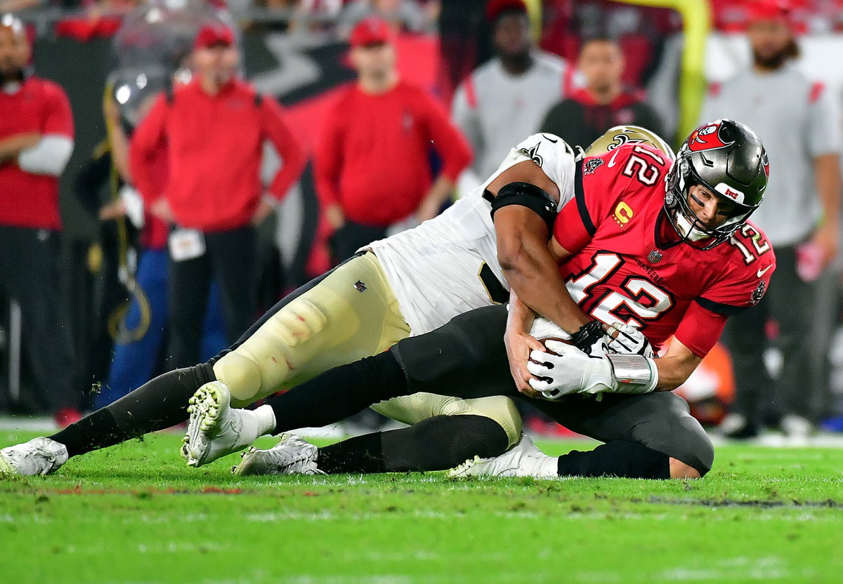 <i>Julio Aguilar/Getty Images</i><br/>Brady is sacked by Marcus Davenport.