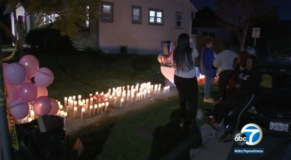 <i>KABC</i><br/>Mourners stand near a memorial for four people who were killed at a birthday party in Inglewood