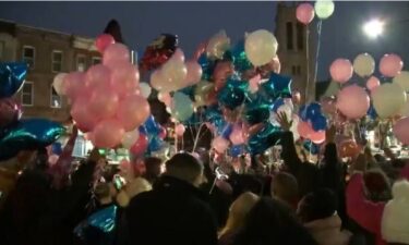 Mourners release balloons in memory of 50-year-old Desiree Charmaine Whitehead Jainlett