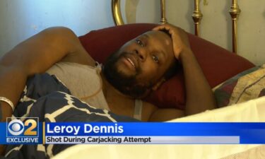 Leroy Dennis lay in bed in his Chicago home. Dennis is recovering after he was shot on the way to work by someone trying to take his car.