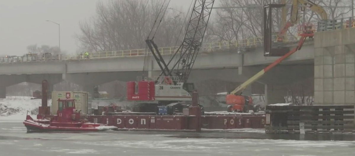 <i>WNEM</i><br/>The crane was brought to the bridge by way of a barge that was assembled on the water