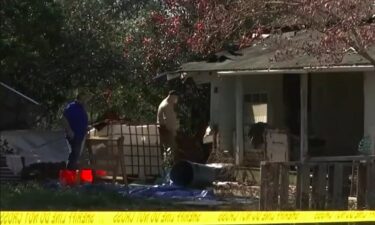 Mobile County Sheriff's Office investigators are seen at a Lott Road home were a body was found buried beneath the floorboards.