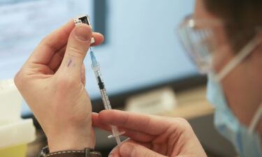 A health care worker in Montreal prepares a dose of the Pfizer/BioNTech Covid-19 vaccine in March 2021.