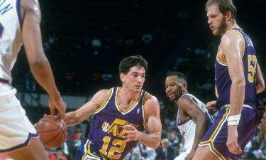 John Stockton of the Utah Jazz drives towards the basket past Michael Adams (#10) of the Washington Bullets during a 1991 NBA basketball game.