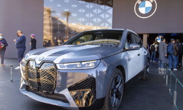 The BMW iX Flow car changes color between white and dark gray.