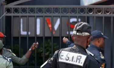 Policemen stand guard at the entrance of the night-club in the Bastos district of Yaounde