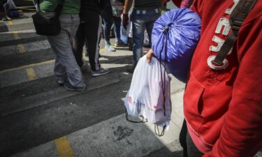 The Biden administration begins quietly flying Venezuelan migrants to Colombia. Pictured is a group of Venezuelan migrants gathered at the immigrant aid center in Sibate