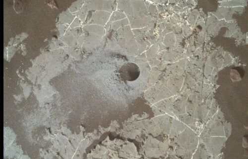 The image shows a drill hole made by Curiosity on Mars' Vera Rubin Ridge.
