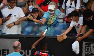 Kyrgios (bottom C) gives a racket to a boy he had hit with a tennis ball.