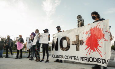 Protesters hold a banner during a demonstration against the murder of the three journalists Jose Luis Arenas