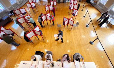 Election workers check in people as voters cast their ballots in Kennebunk