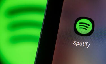 Spotify is making public platform rules that cover Covid-19 misinformation. Pictured is the Spotify app logo on the screen of a smartphone.