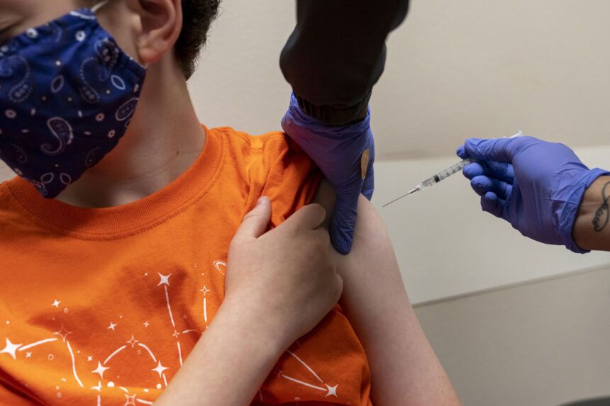 A health care worker administers a dose of the Pfizer-BioNTech Covid-19 vaccine to a child in Oklahoma City in 2021.