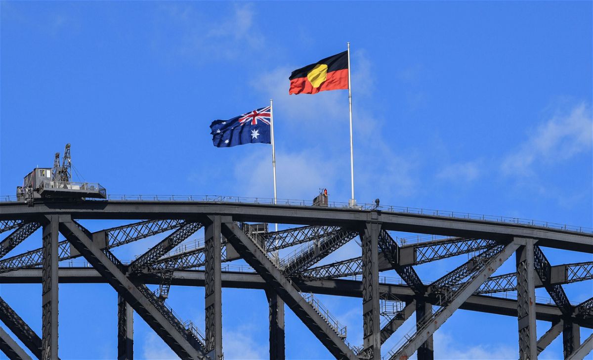 <i>James D. Morgan/Getty Images</i><br/>The Australian national flag flies alongside the Aboriginal flag atop the Sydney Harbour Bridge on May 26