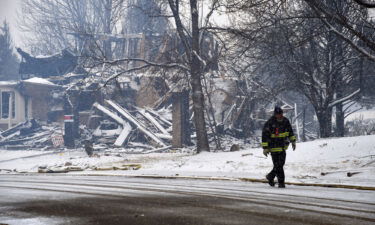 A destroyed home is covered in snow in Louisville