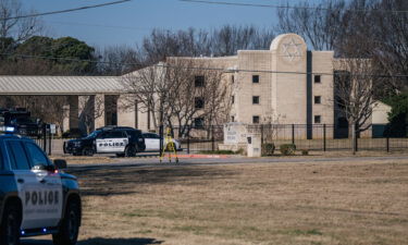 Police vehicles sit outside of Congregation Beth Israel Synagogue in Colleyville