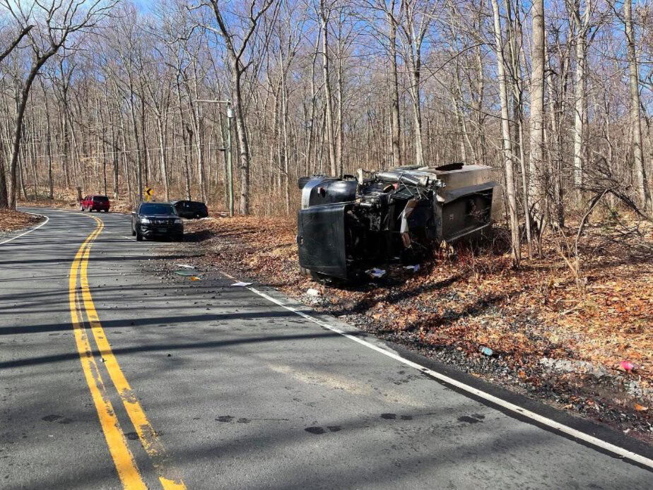 <i>Cheshire Voluntee Fire Dept/WFSB</i><br/>Cheshire Police investigate an oil truck rollover crash.