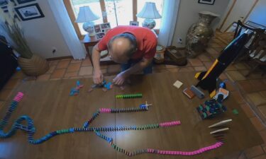 Gloria Woodman and Robert Dehate have turned their love of dominos into a never-ending challenge to build something bigger and better every time they gather around the dining room table or pour a pack of dominos on the floor.