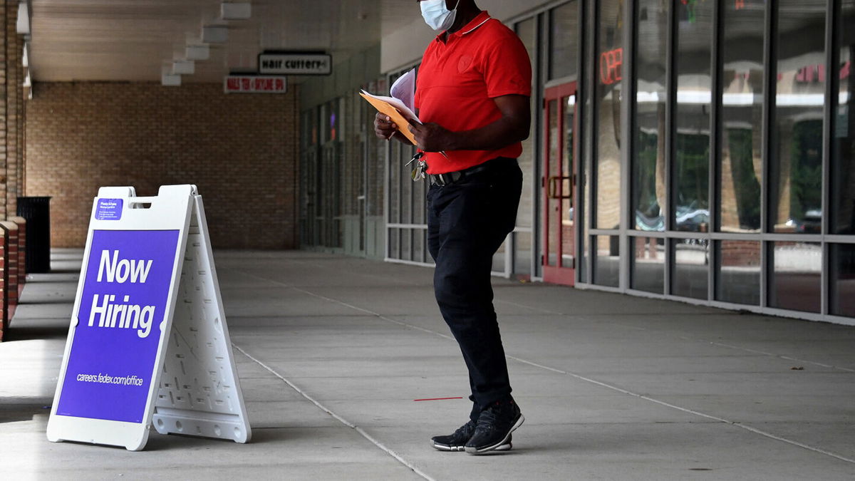 <i>Olivier Douliery/AFP/Getty Images</i><br/>Pedestrians walk by a 