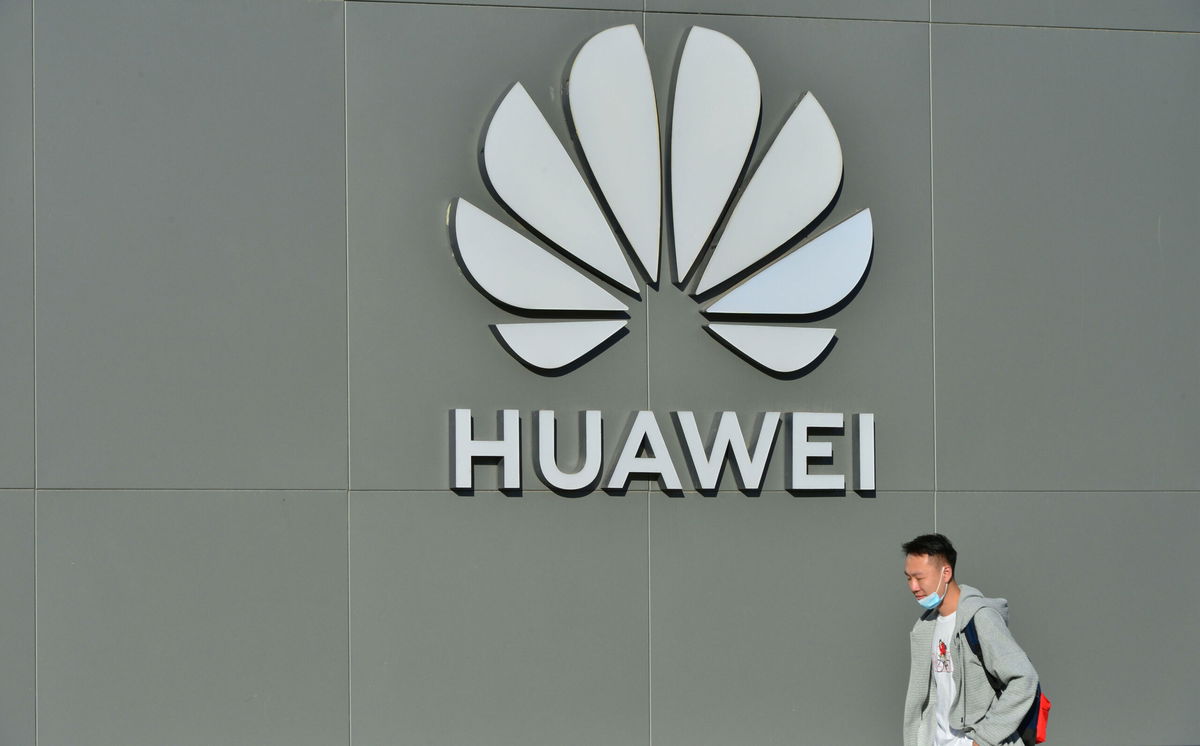 <i>VCG/Getty Images</i><br/>A man walks past a Huawei store on October 12