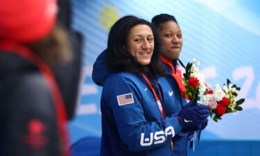 Meyers Taylor and Hoffman look on from the podium during the flower ceremony on Saturday.