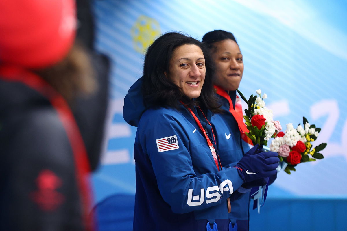 <i>Julian Finney/Getty Images</i><br/>Meyers Taylor and Hoffman look on from the podium during the flower ceremony on Saturday.