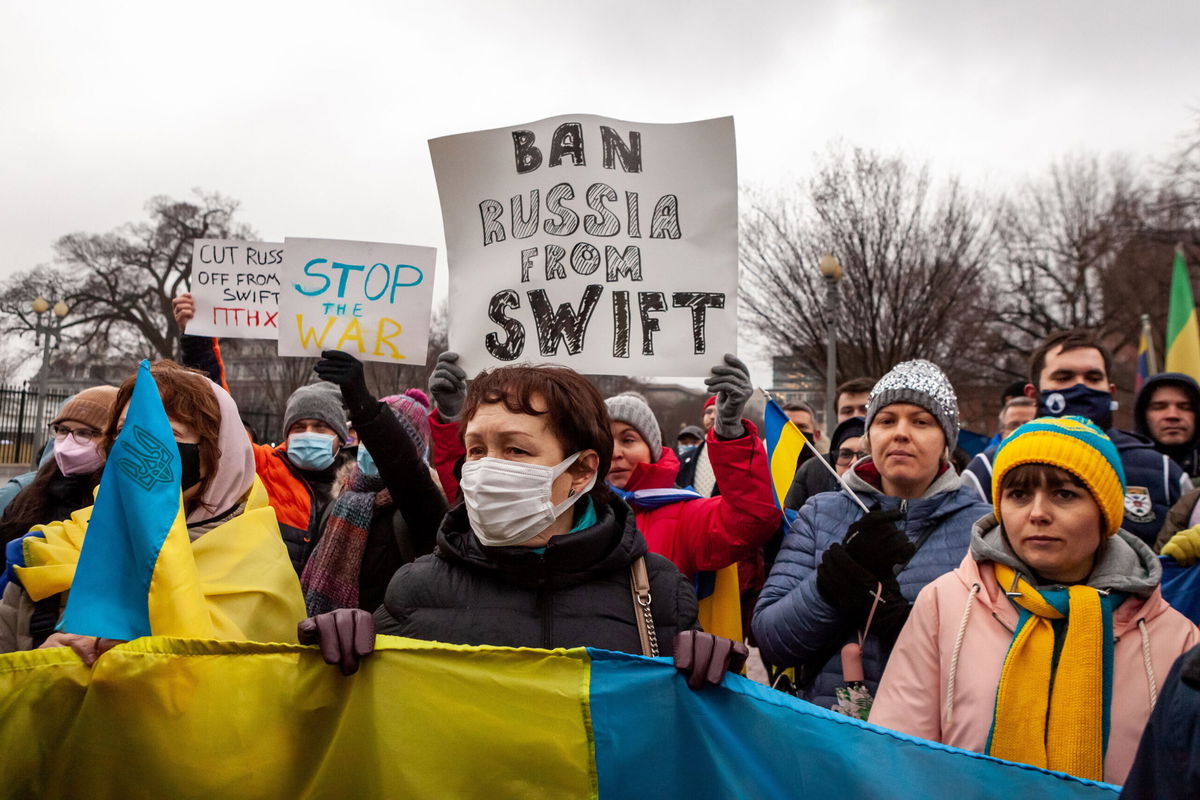 <i>Allison Bailey/NurPhoto/Shutterstock</i><br/>Protesters demand that Russia be banned from the SWIFT system during a rally for Ukraine at the White House.  This system facilitates international interbank transactions