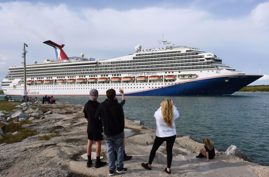 People watch as the Carnival Liberty cruise ship departs from Port Canaveral. Carnival Cruises will be relaxing its mask rules. A release from the company indicated masks will be recommended but not required on board from sailings departing on and after March 1.