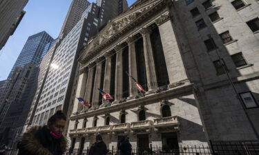 Pedestrians walk past the New York Stock Exchange