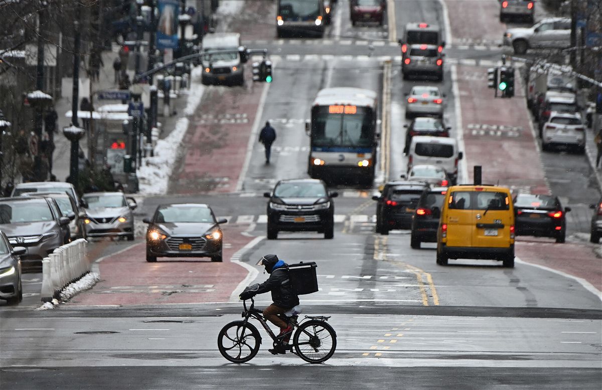 <i>Angela Weiss/AFP/Getty Images</i><br/>A man on a delivery bike rides in the street after a winter storm hit New York City
