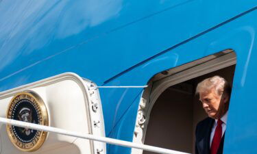 Outgoing President Donald Trump steps off Air Force One as he arrives at Palm Beach International Airport in West Palm Beach