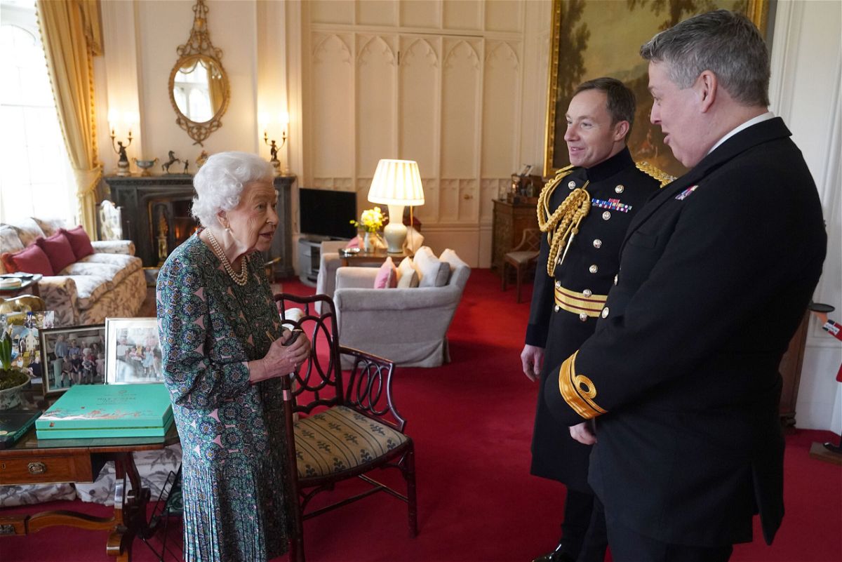 <i>Steve Parsons/WPA Pool/Getty Images</i><br/>Queen Elizabeth II speaks with Rear Admiral James Macleod and Major General Eldon Millar (right) in the Oak Room at Windsor Castle on February 16.