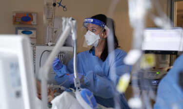 A healthcare worker treats a Covid-19 patient on the Intensive Care Unit floor at Hartford Hospital in Hartford