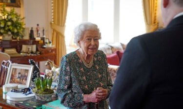 Britain's Queen Elizabeth II speaks with incoming Defence Service Secretaries Major General Eldon Millar (R) during an in-person audience at the Windsor Castle