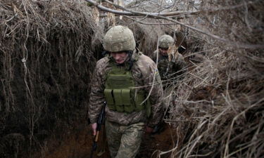 Servicemen of Ukrainian Military Forces walk as they keep position on the front line with Russia backed separatists