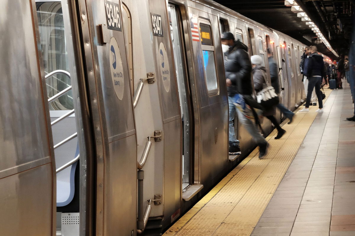 <i>Spencer Platt/Getty Images</i><br/>People board a subway on January 19 in New York City. One man died and another was injured after they were struck by subway trains in different areas of New York City within hours of each other Saturday night