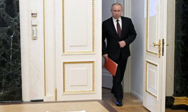 Russian President Vladimir Putin arrives to chair a Security Council meeting via a video link in Moscow on February 25.